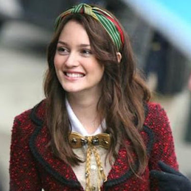 Blair Waldorf wearing our Jamaica headband and red textured jacket with a blurred background