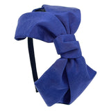 A blue grosgrain headband featuring an oversized bow.
