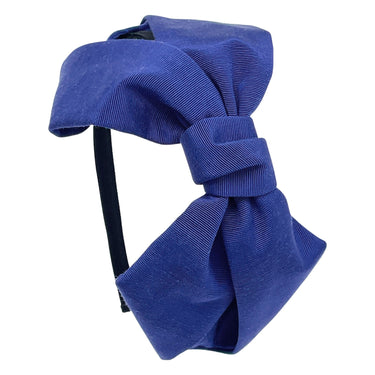 A blue grosgrain headband featuring an oversized bow.
