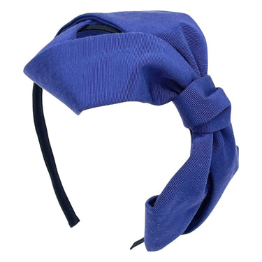 A blue grosgrain headband featuring an oversized bow.