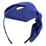 A blue grosgrain headband featuring an oversized bow.