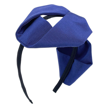 A blue grosgrain headband featuring an oversized bow.