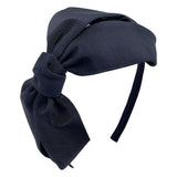 A black grosgrain headband featuring an oversized bow