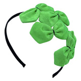 A green grosgrain headband adorned with multiple bows with black stitching 