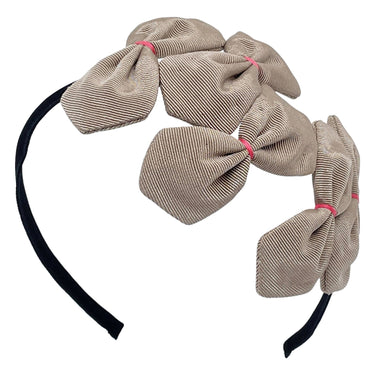 A beige and black grosgrain headband adorned with multiple bows with pink stitching on a white background.
