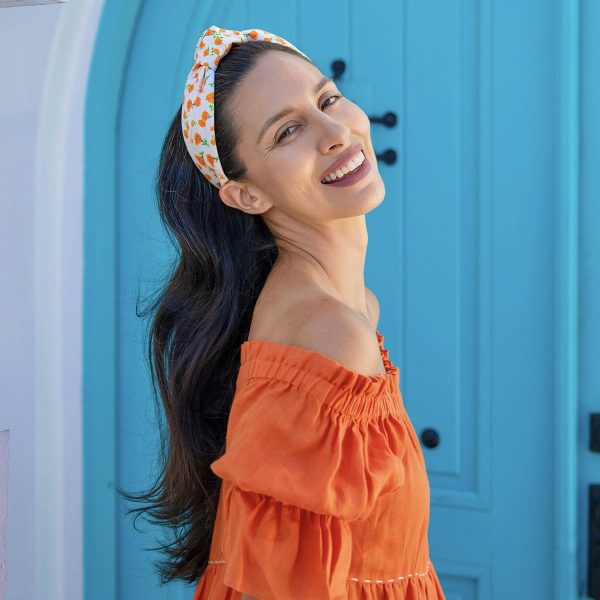 Carolyn Carter wearing our Orange Poppy Floral Center Turban Headband CP64