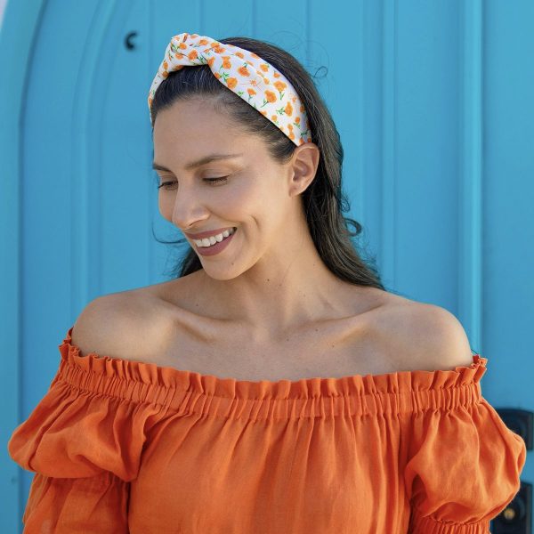 Carolyn Carter wearing our Orange Poppy Floral Center Turban Headband CP64